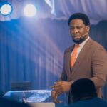 Apostle Femi Lazarus speaking at a church service in Kenya during ministry visit