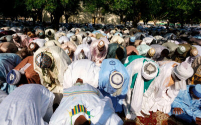 Muslims in Nigeria observing Eid-el-Adha prayers in a large outdoor gathering promoting peace and unity
