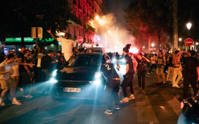 PSG supporters celebrating Champions League victory amid clashes with police in Paris