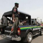 Police officers responding to a reported security scare at a school in Abuja.