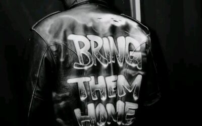 Davido performing at the FIFA World Cup Countdown Concert while wearing a jacket calling for the release of abducted Oyo schoolchildren.