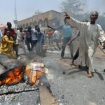 Residents in Nasarawa burning Governor Abdullahi Sule campaign posters and APC brooms during protest