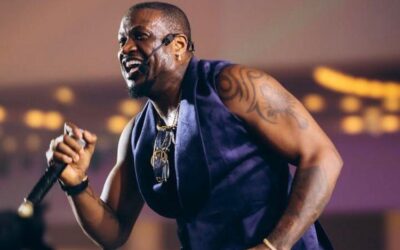 Peter Okoye performing on stage during a live music event.