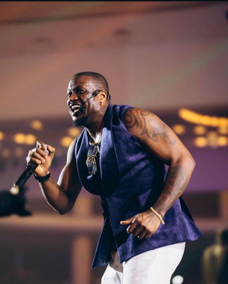 Peter Okoye performing on stage during a live music event.