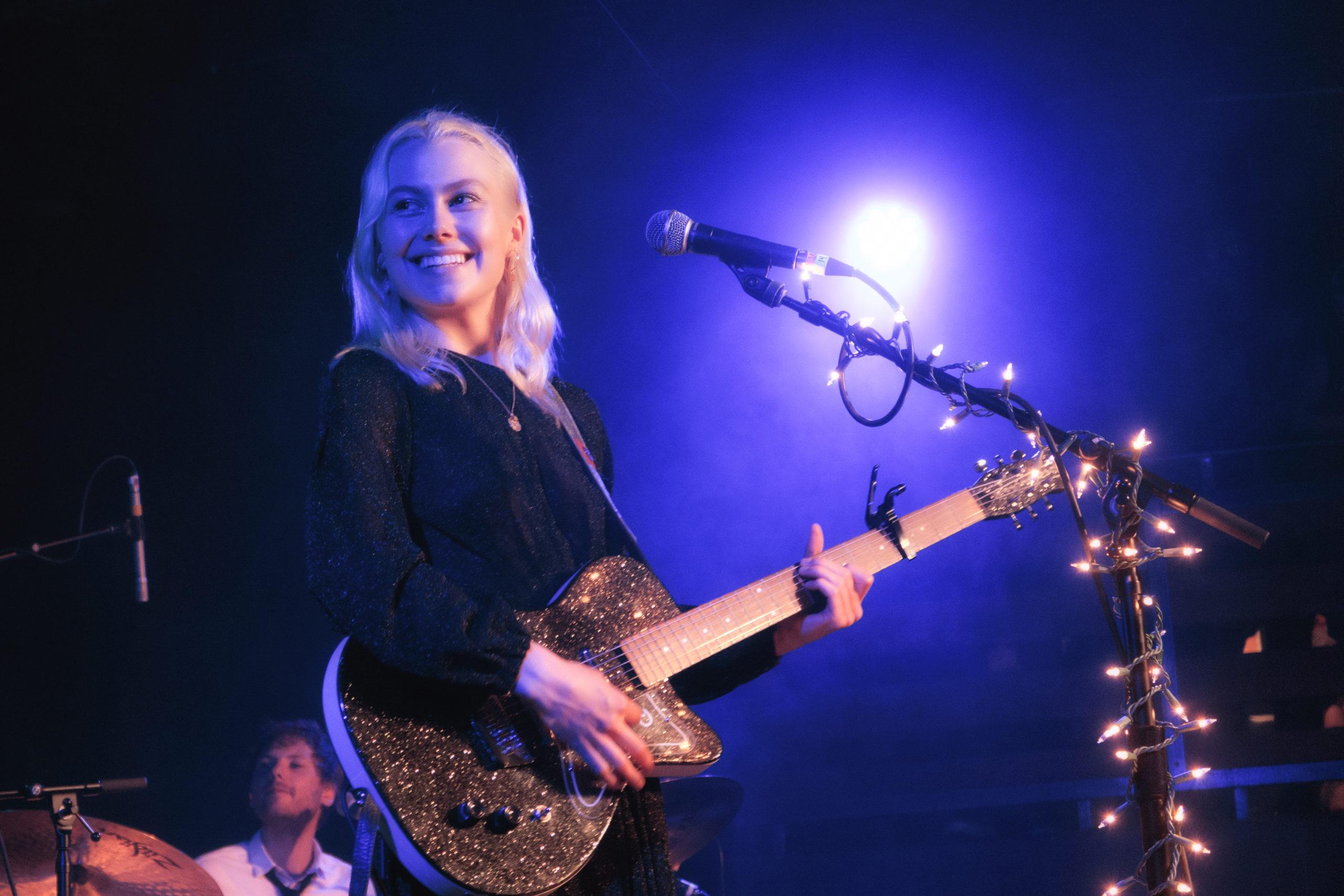 Phoebe Bridgers performing live during concert after announcing 2026 Lost Tour