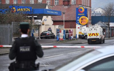 Police officers at the scene of a knife attack in Belfast where a man was seriously injured.