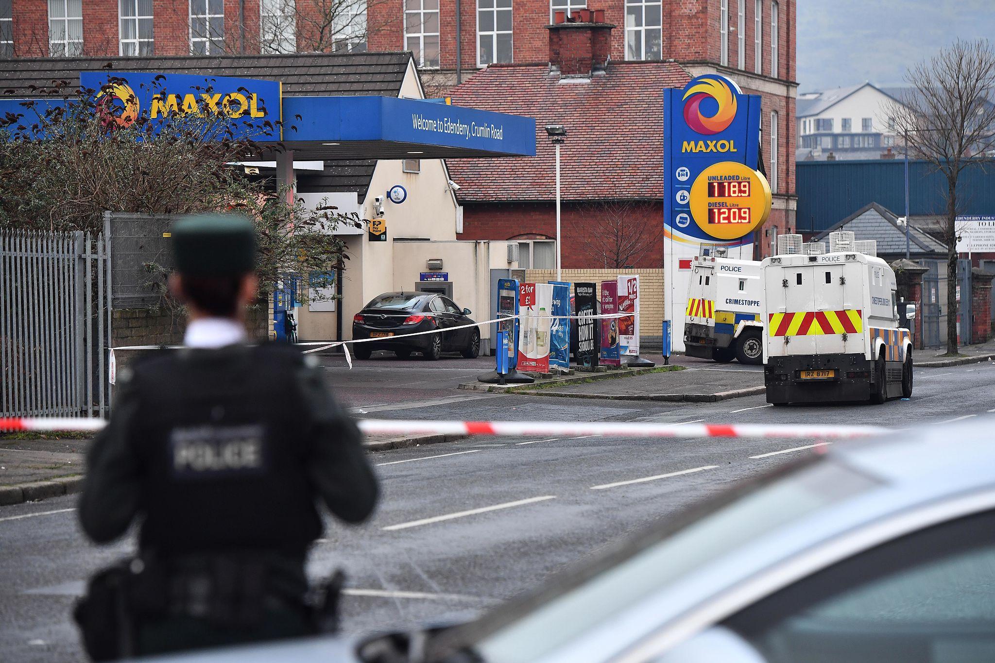 Police officers at the scene of a knife attack in Belfast where a man was seriously injured.