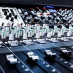 Music producer working inside a recording studio.
